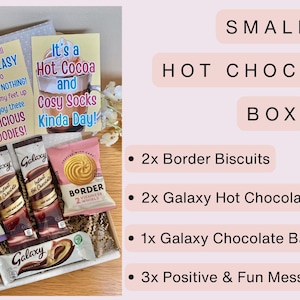 May include: A small hot chocolate box containing two Border biscuits, two Galaxy hot chocolate sachets, one Galaxy chocolate bar, and three message cards with text including Today I plan to Relax and Recharge, Take It Easy, and It's a Hot Cocoa and Cosy Socks Kinda Day.