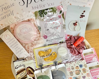 May include: A self-care gift box containing a bag of pink bath soak, a flamingo hair mask, a shea butter sheet mask, gold under-eye patches, a pink scrunchie, lip balm, two Galaxy hot chocolate packets, two Zanyah pouches, and Twinings tea.