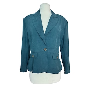 May include: Teal-colored blazer with a notched collar, long sleeves, and a single-button closure. The blazer features two front pockets and a tailored fit. The fabric has a subtle texture, giving it a sophisticated look. The garment is displayed on a mannequin.
