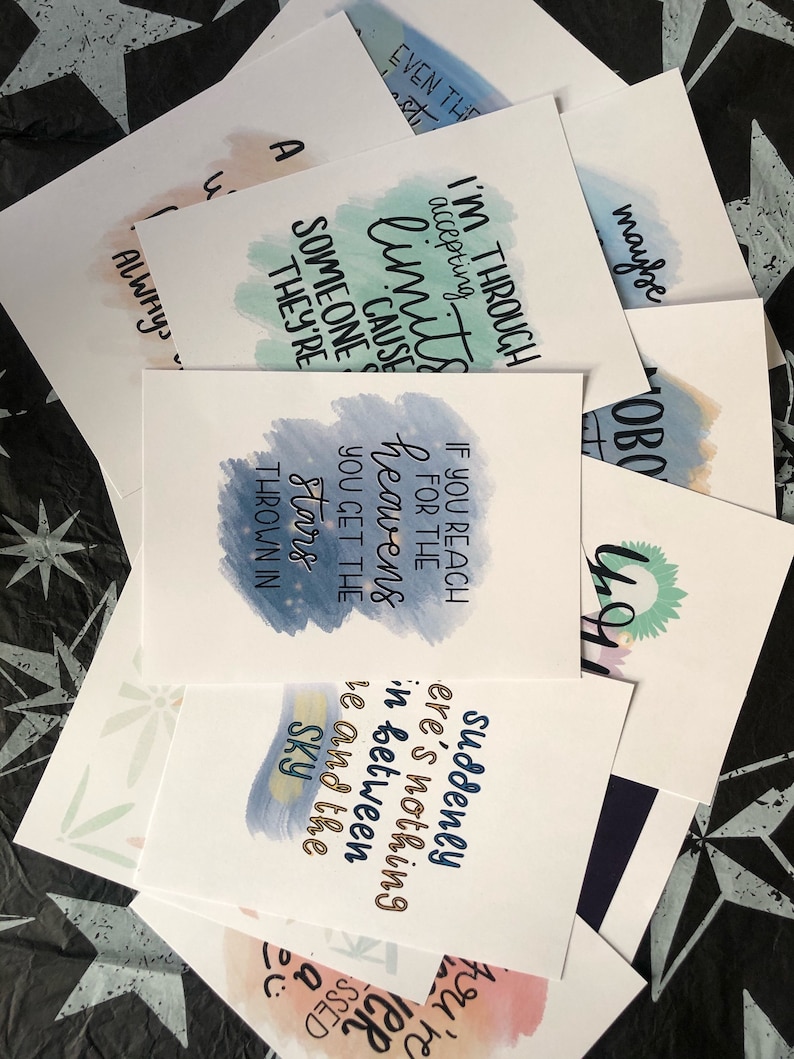 May include: A set of 10 watercolor cards with inspirational quotes. The cards feature a variety of colors, including blue, green, and pink. The quotes are printed in black ink and are centered on the cards. The cards are perfect for adding a touch of inspiration to your home or office.
