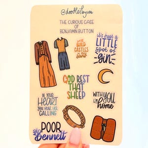 May include: A sticker sheet featuring illustrations and quotes from "The Curious Case of Benjamin Button." Designs include clothing, a tambourine, a crescent moon, and phrases like "God Rest That Sheep" and "It's Just a Little Spot of Gin."