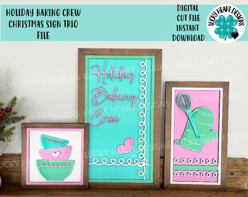 May include: Three wooden signs with a Christmas baking theme. The signs are decorated with a teal, pink, and white color scheme. The text on the signs reads "Holiday Baking Crew".