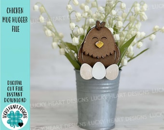 May include: A wooden chicken mug hugger with closed eyes and a yellow beak, sitting on three white eggs. The chicken is in a silver metal bucket with a bouquet of white lily of the valley flowers.