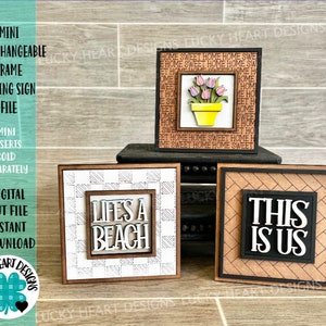 May include: Three interchangeable wooden signs with different designs. The first sign has a white background with a black and white checkered pattern and the text "Life's a Beach". The second sign has a brown background with a black and white checkered pattern and the text "Home Sweet Home" repeated. The third sign has a brown background with a black and white herringbone pattern and the text "This is Us".