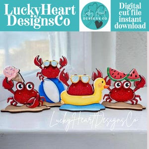May include: A collection of red glittery crab cutouts, each with unique summer-themed accessories. One crab holds an ice cream cone, another wears sunglasses and sits on a beach ball, and another on a yellow duck float. The text "Lucky Heart Designs Co" is visible.