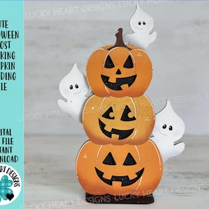 May include: A Halloween-themed wooden decoration featuring three stacked orange pumpkins with carved faces and three white ghost figures. The text on the left side reads "CUTE HALLOWEEN GHOST STACKING PUMPKIN STANDING FILE".