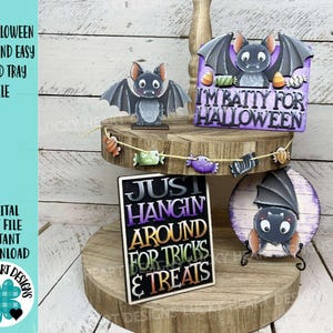 May include: A wooden tiered tray display featuring Halloween-themed bat decorations. The display includes a freestanding bat, a sign that reads "I'm Batty for Halloween," and another sign that says "Just Hangin' Around for Tricks & Treats." A garland of candy corn and other treats is strung across the display.