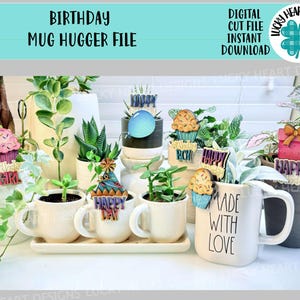 May include: A collection of white mugs and planters with birthday-themed decorations. The decorations include cupcake and gift box cutouts, and the text "HAPPY" and "MADE WITH LOVE". The image also includes the text "BIRTHDAY MUG HUGGER FILE".