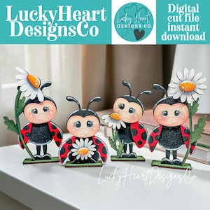May include: Four wooden ladybug figurines with red and black wings, holding daisies. Each ladybug has a smiling face and is standing on a green base. The image includes the text "LuckyHeart DesignsCo" and "Digital cut file instant download."
