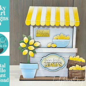 May include: A wooden lemon stand with a yellow and white striped awning. The stand features a sign that reads "$5/DOZEN" and "farm fresh LEMONS". A potted lemon tree and crates of lemons are also visible.