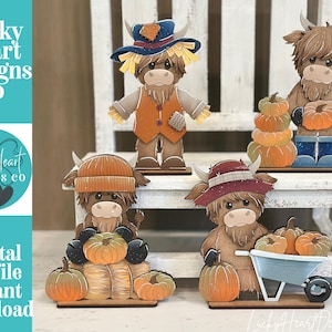 May include: Four flat wooden cutout figures of Highland cows with autumn themes. One wears a scarecrow hat, one holds a pumpkin, one sits with pumpkins and hay, and one stands with a wheelbarrow of pumpkins. Text reads Lucky Heart Designs Co.