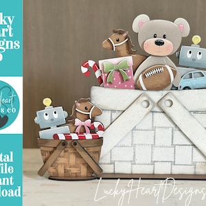 May include: Two wooden basket-shaped tiered tray decorations featuring Lucky Heart Designs Co branding. The larger white basket holds a teddy bear with a football, a horse, a gift box, a robot, a car, and candy canes. The smaller brown basket holds a robot, a horse, and a candy cane.