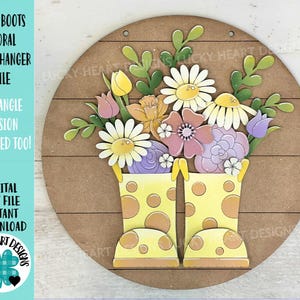May include: A round wooden door hanger with a yellow rain boot design. The boots are filled with a bouquet of colorful flowers, including pink, purple, yellow, and white. The text "LUCKY HEART DESIGNS" is visible in the lower right corner.