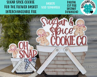 Puede incluir: Un recorte de madera de un hombre de jengibre sosteniendo una cesta con el texto "Sugar & Spice Cookie Co." y un recorte más pequeño de un hombre de jengibre sosteniendo una cesta con el texto "Oh Snap".