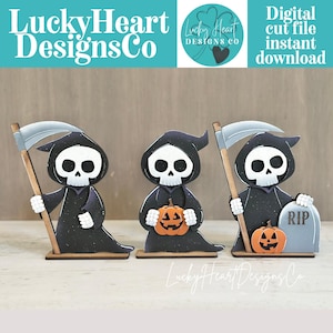 May include: Three flat wooden reaper figures with white skulls and black robes. The left figure holds a scythe, the center holds an orange jack-o'-lantern, and the right holds a scythe next to a gray tombstone with RIP text and a small pumpkin.
