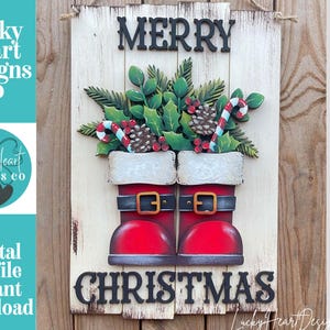 May include: A rectangular wooden wall sign with a distressed white finish featuring the text MERRY CHRISTMAS in black lettering. The design includes a pair of red Santa boots with black belts and green holly leaves, pinecones, and candy canes.