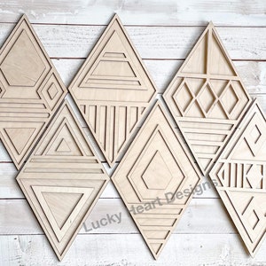 May include: Set of six wooden diamond-shaped wall decor pieces with geometric patterns. Each piece features a different design, including triangles, squares, and lines. The pieces are made of natural wood and have a light brown color.