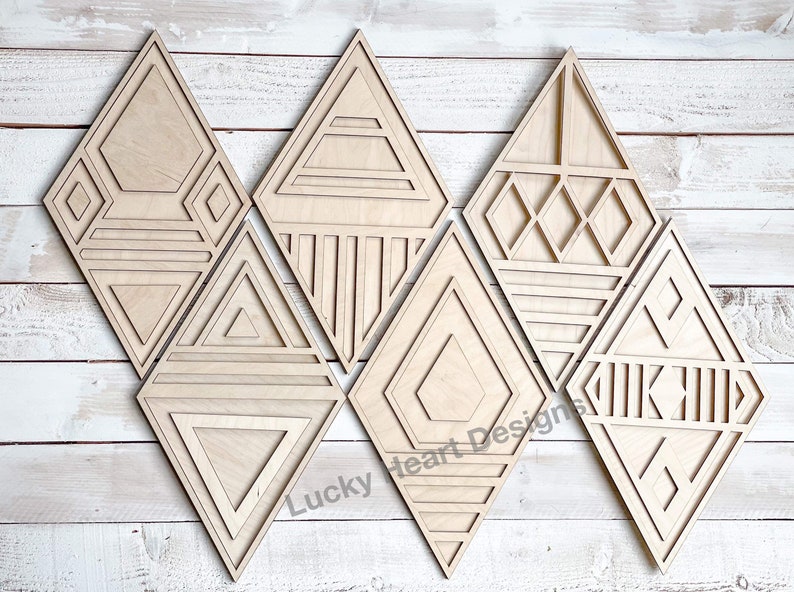 May include: Set of six wooden diamond-shaped wall decor pieces with geometric patterns. Each piece features a different design, including triangles, squares, and lines. The pieces are made of natural wood and have a light brown color.