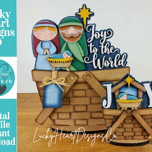 May include: A wooden Christmas nativity scene with Mary, Joseph, and baby Jesus in a manger. The scene is set in a basket with the words "Joy to the World". A star and the words "Holy Night" are also included.