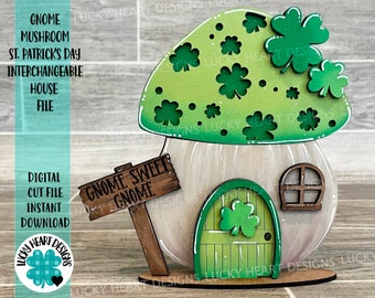 May include: A green and white gnome mushroom house with a sign that reads "Gnome Sweet Gnome". The house has a green door with shamrocks and a window. The mushroom top is decorated with shamrocks.