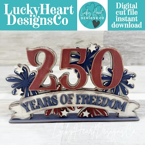 May include: A wooden patriotic decoration with the number "250" in red, surrounded by blue and white fireworks. The banner reads "YEARS OF FREEDOM". The design includes the text "Lucky Heart Designs Co" and "Digital cut file instant download".