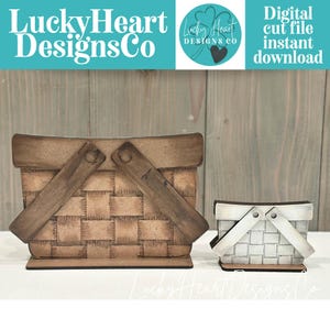 May include: Two wooden picnic basket cut files. The larger basket is brown with a woven design and wooden handle. The smaller basket is white with a woven design and wooden handle. Text on the image reads "Lucky Heart Designs Co" and "Digital cut file instant download."
