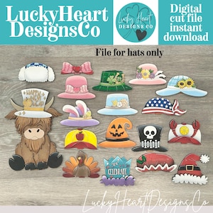 May include: A digital cut file set featuring a cartoon highland cow and various seasonal hats including a New Year top hat, St. Patrick's Day green hat, pumpkin hat, turkey, and Santa hat. The text reads LuckyHeartDesignsCo and File for hats only.