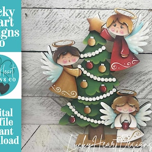 May include: A wooden Christmas tree with three angel figures. The tree is green with red and gold ornaments. The angels have halos, wings, and are dressed in red, gold, and white. The image includes the text "Lucky Heart Designs Co" and "Digital cut file instant download."