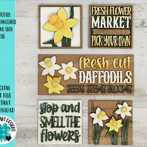 May include: Four wooden signs with a spring theme. The signs feature daffodils, the text "Fresh Flower Market", "Fresh Cut Daffodils", and "Stop and Smell the Flowers".