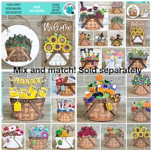 May include: A collection of interchangeable wooden basket signs with various themes, including sunflowers, pumpkins, honey, and a rainbow. The signs are sold separately and can be mixed and matched to create custom decor.