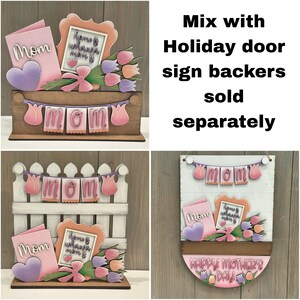 May include: Mother's Day wooden decorations with the word "Mom", a heart, flowers, and a framed message. The decorations are in pink, purple, and orange hues, with the text "Happy Mother's Day".