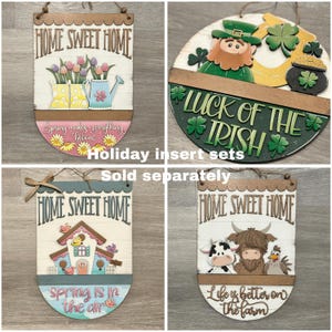 May include: Wooden home decor signs with various designs. One sign features a watering can and flowers, another has a leprechaun and shamrocks, a third has a birdhouse, and the last has farm animals. Each sign has the words "Home Sweet Home".