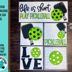 May include: Set of five interchangeable pickleball-themed leaning signs. The signs feature a variety of designs, including a paddle and ball, the words "Life is short, play pickleball", and the phrase "It's a good day to play pickleball".