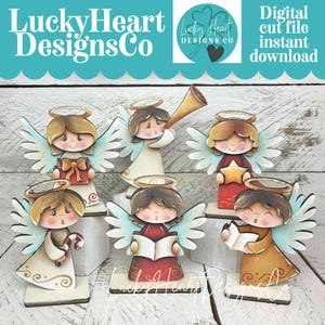 May include: A collection of six wooden angel figurines with painted details. Each angel has a halo, wings, and is holding a different item, such as a gift, star, or book. The image includes the text "LuckyHeart Designs Co" and "Digital cut file instant download."