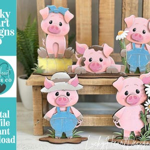 May include: A collection of pink pig cutouts with various accessories, including a blue bow, overalls, and a straw hat. Some pigs hold flowers. The image includes the text "Lucky Heart Designs Co" and "Digital cut file instant download".