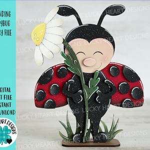 May include: A red and black ladybug with black spots stands on a wooden base with green grass. The ladybug is holding a white daisy with a yellow center. The image is a digital cut file for crafting.