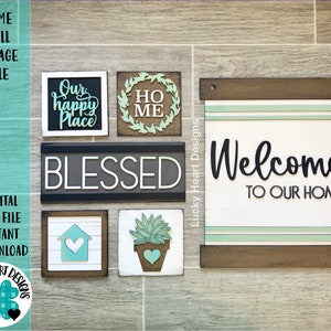 以下が含まれることがあります： 農家のテーマの6つの木製看板のセット。看板には、「Our happy Place」、「Blessed」、「Welcome to Our Home」、「Home」、「Ho Me」の文字が書かれています。看板は茶色、白、緑の色合いで塗られています。