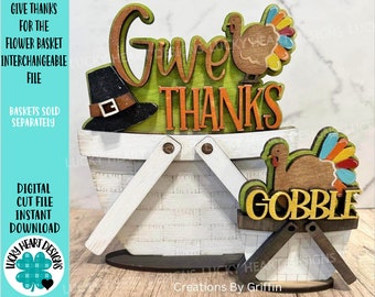 May include: A wooden craft project featuring a white basket with the words "Give Thanks" and a turkey. A smaller basket with the words "Gobble" and a turkey is in the foreground.