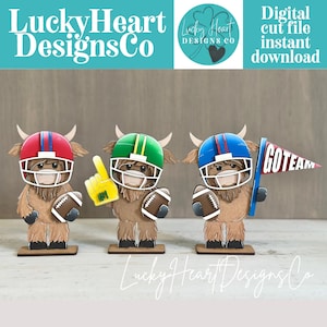 May include: Three Highland cow figurines wearing football helmets and holding footballs. One cow has a foam finger, and another holds a pennant that says "GO TEAM". The image includes the text "Lucky Heart Designs Co" and "Digital cut file instant download".