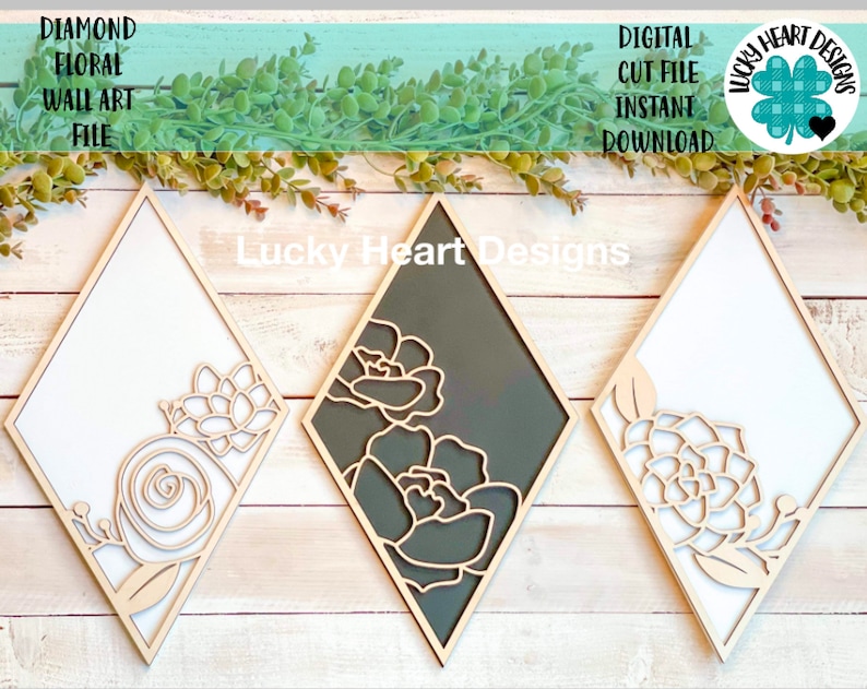 May include: Three diamond-shaped wall art pieces with floral designs. The frames are light wood, with white and dark gray backgrounds. The floral cutouts are in a natural wood tone. Text on the image reads "Diamond Floral Wall Art File" and "Digital Cut File Instant Download."