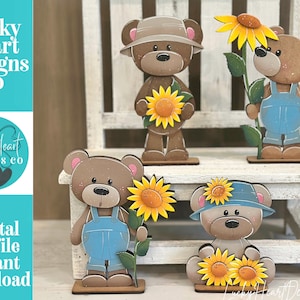 May include: Four brown bear figurines with sunflower accents. One bear wears a tan hat, one wears blue overalls and holds a tall sunflower, one wears blue overalls and holds a sunflower, and one wears a blue hat with two sunflowers.