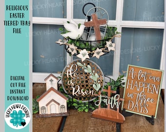 May include: A tiered tray decorated for Easter with a white dove, a cross, a sign that says "He is Risen", a sign that says "Faith", and a sign that says "A lot can happen in three days".