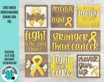 Könnte beinhalten: Acht austauschbare Holzschilder mit gelben Schleifen-Designs und inspirierenden Botschaften zur Krebsvorsorge. Die Schilder zeigen Sätze wie "Hope", "Fight is the only choice", "Stronger than cancer", "Never give up" und "Friends don't let friends fight alone".