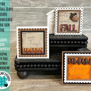 May include: Three wooden signs with fall-themed designs. The signs are decorated with a scalloped border and feature the text "Farm Fresh Pumpkins", "Nuts About Fall", and "Pumpkin Spice Season".