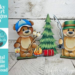 May include: Wooden cutouts of camping bears. One bear wears a blue cap and holds marshmallows on a stick. The other bear wears a green hat and holds a fishing rod and a fish. A green tree, campfire, and red sleeping bag are also included.