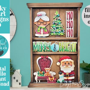 May include: A wooden tiered display shelf featuring Christmas-themed cutouts including a grandmother figure, a decorated tree, a sign reading HO HO HO, a MERRY & BRIGHT sign, a red armchair with a teddy bear, and a Santa Claus figure with a stocking.