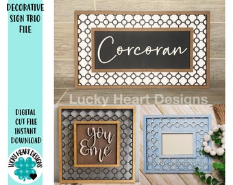 May include: A trio of decorative wooden signs. One sign features the name "Corcoran" in white script on a black background, framed by a geometric pattern. Another sign says "you & me". The third sign has a blue frame.