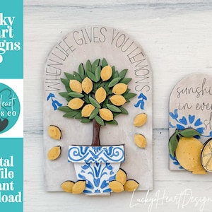 May include: Wooden decorative signs with lemon tree and lemon slice designs. One sign reads "When life gives you lemons" and the other says "Sunshine in every slice". Both signs have blue and white accents.