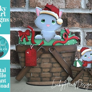 May include: A wooden Christmas decoration featuring a gray cat wearing a Santa hat, sitting in a basket with a green base and red ribbon. The basket has a handle and the text "MEOWY CHRISTMAS" on a tag. A smaller version is also present.