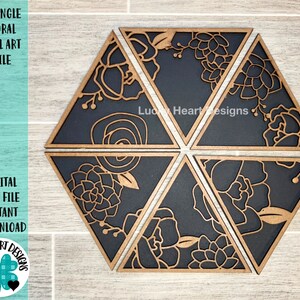 May include: Six black and gold wooden triangles with floral designs form a hexagon. The triangles are cut out with a floral pattern. The text "Lucky Heart Designs" is visible in the center of the hexagon.